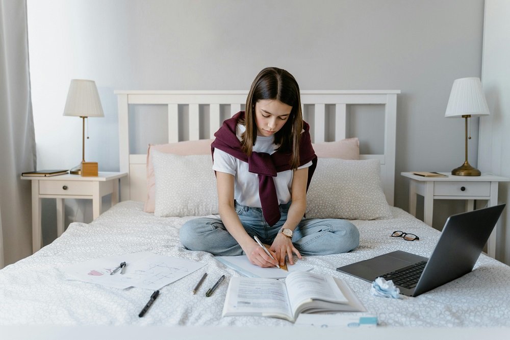 Doing homework on a firm double bed